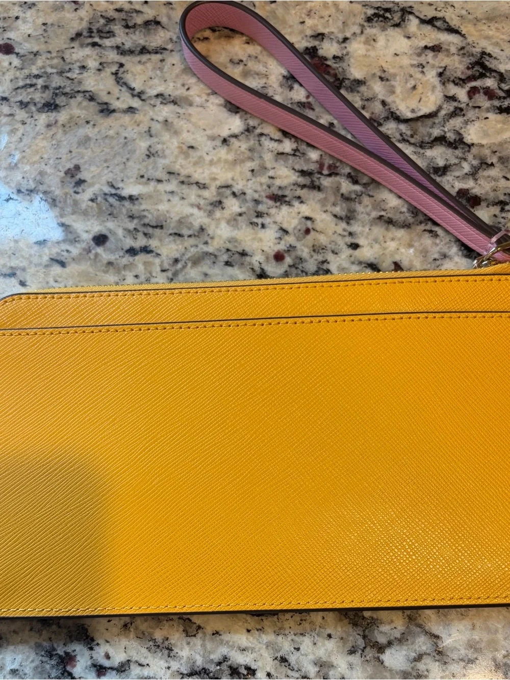 Best offer for quick sale Kate Spade Pink/Yellow  Wristlet with Gold lettering.